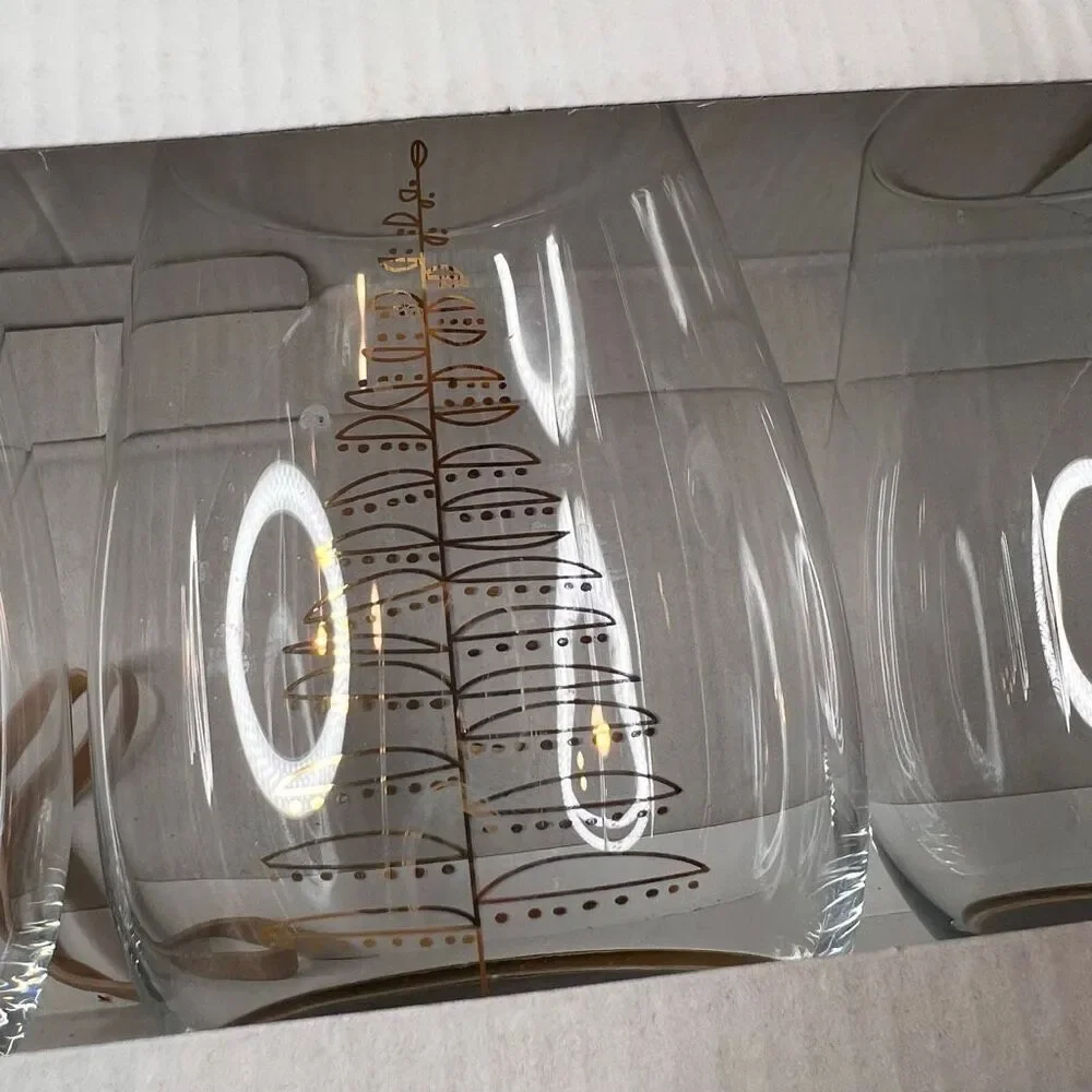 Crate & Barrel boxed set of 4 stemless wine glasses featuring a holiday tree des